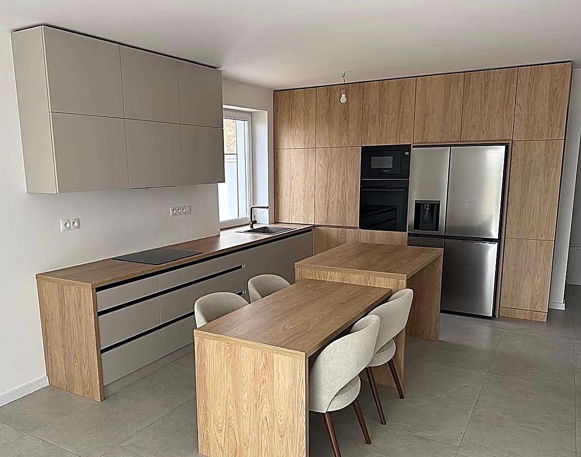 Karen Hill Apartment — Open-plan kitchen with oak-effect cabinetry, breakfast island and cream wall units in a Karen Hill apartment, Nairobi, by Epique Interiors.